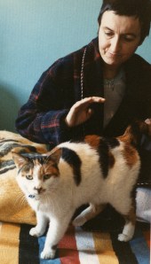 woman in dressingown with calico cat